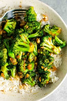 a white bowl filled with rice and broccoli