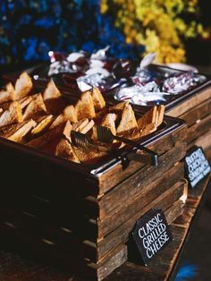 a wooden box filled with baked goods on top of a table