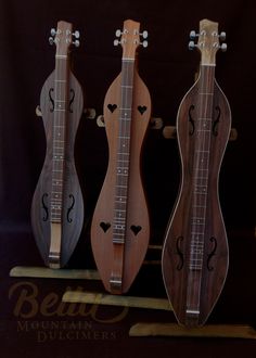 three ukulele guitars are on display together