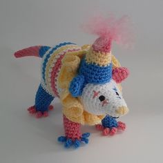 a crocheted stuffed animal wearing a colorful hat