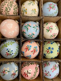 an assortment of painted eggs in cardboard boxes