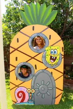 two people are in a fake pineapple house with pictures on the front and side