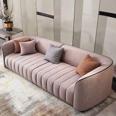 a living room with a couch, rug and table in front of the wall that has vertical striped panels on it