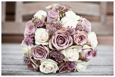 a bridal bouquet with purple and white flowers