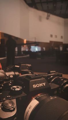 the sony camera is sitting in front of some other cameras