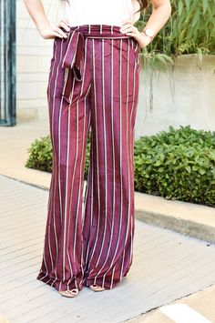 These wine striped pants bring the perfect flair to your closet! Super soft material with pockets and an adjustable bow tie around the waist Waist is synched yet stretchy, flowy fit throughout the leg We love these pants paired with our Lauren Off the Shoulder Top Piper is a size 2-3 in pants and is wearing a small! Wine Night, Red Pants, Bold Stripes, Off The Shoulder Top, Grey Shirt, Striped Pants, Soft Material, Bow Tie, Shoulder Top