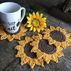 three crocheted sunflower coasters next to a coffee cup