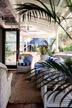 a porch with wicker furniture and plants