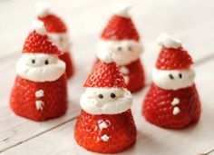 some strawberries with santa clause hats on them