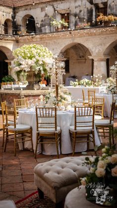 an outdoor dining area with tables and chairs set up for a formal function in the courtyard