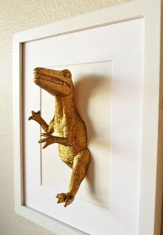 a gold lizard mounted on a white frame