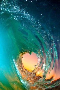 an ocean wave with the sun shining through it's hole in the water,