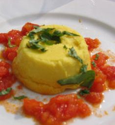 a plate with some food on it and sauces around the edges that are red