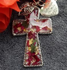 Custom made silver Cross made from your dried flowers from funeral, wedding or any meaningful occasion, Cross measures 2.34 inch by 1.58 inch with two side charms.  Cross can be used as pendant, keychain or Christmas ornament.  Pendant style comes with a 18 inch black cord with a 2 inch extender. Item details, Each item is individually made, resin is poured a mold then I carefully place your dried flowers and resin is again poured over both. Items are all handmade so no two items are the same, the item pictured is a example of your item will look like.  Upon purchase you will receive a email with instructions on how to dry your flowers and where to send them .  Note any left over flowers will be returned to you along with your order. I will start your order just as soon as I receive your d Personalized Silver Keychain Gift, Silver Keychain With Lobster Clasp As Gift, Handmade Silver Keychain As Gift, Handmade Silver Keychain For Gift, Silver Keychain With Lobster Clasp For Gift, Handmade Silver Keychains For Gifts, Custom Cross, Silver Cross, Dried Flowers