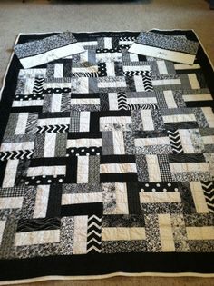 a black and white quilt on the floor