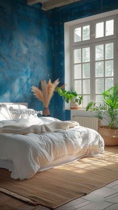 a bed sitting in a bedroom next to a window with potted plants on top of it