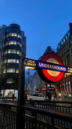 the underground sign is lit up at night