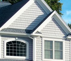 a gray house with white trim and windows