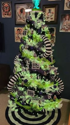 a green christmas tree with black and white decorations