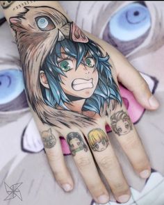 a woman's hand with tattoos on it and an anime character painted on the palm