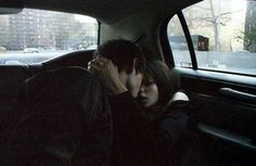 a man and woman kissing in the back seat of a car, with text above them