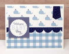 a welcome baby boy card with blue and white checksered paper on the bottom corner