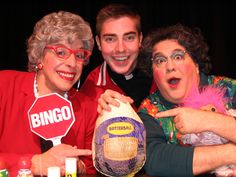 two women and a man posing for the camera with an egg in front of them