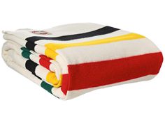 four towels stacked on top of each other with different colors and designs in the middle