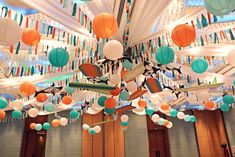 the ceiling is decorated with paper lanterns and streamers