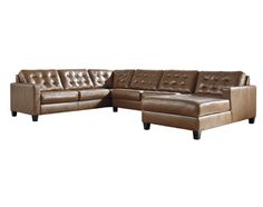 a brown leather sectional sofa sitting on top of a white floor