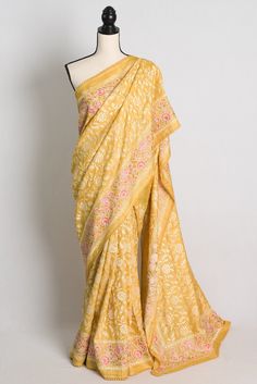 Experience the epitome of elegance and luxury with our premium quality Parsi Embroidery Saree in yellow Tussar silk. This beautiful saree boasts exclusive heavy machine Parsi embroidery work on pure Gachi by Gachi Tussar silk, making it a true work of art. The intricate embroidery work showcases the rich cultural heritage of India, while the soft and lightweight Tussar silk fabric drapes beautifully, making you feel like royalty. Perfect for special occasions or as a cherished addition to your saree collection, this saree truly embodies the essence of premium quality and craftsmanship. Order yours today and experience the beauty and sophistication of a true Indian saree. Color : Yellow, Pink and Cream Resham Thread.   Blouse Piece : Yes ( cut and separated from the saree ). Fall Pico : Yes Parsi Embroidery, Embroidery Saree, Indian Embroidery, Readymade Blouse, Indian Sari, Chiffon Saree, Simple Doodles, Draped Fabric, Beautiful Saree