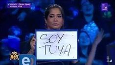 a woman holding up a sign that says soy tuya