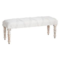 an upholstered bench with wooden legs and a white fabric seat cover on it