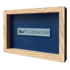 a wooden frame with the words yes to adventure on it