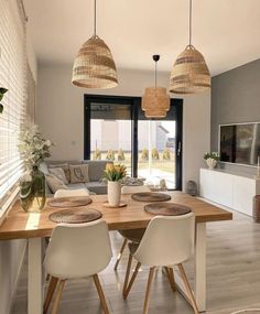 a living room with white chairs and a wooden table