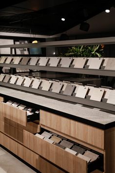 an empty counter in a store filled with lots of boxes and folders on it