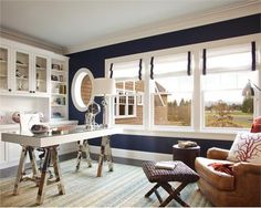 a living room filled with furniture and lots of windows