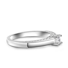 Simple and stunning, this ring showcases a magnificent round cut stone standing tall in the traditional four-prong setting, while additional round stones line the shank. So elegant it needs no further accompaniment, this ring is finished with a bright polished shine. The stones in this engagement ring shine brightly enough to be deserving as a symbol of your love.Carat Weight: 0.275 ctStone Size: 4 mmStone Type: Jeulia® StoneNumber of Stones: 1 Stone Color: Diamond WhiteStone Shape: RoundCarat Weight: 0.648 ctStone Size: 1.1,1.3,1.5 mmStone Type: Jeulia® StoneNumber of Stones: 32 Stone Color: Diamond WhiteStone Shape: RoundWeight: 2.7 gWidth: 1.7 mmHeight: 4.9 mmThickness: 1.2 mmMaterial: 925 SilverPlating Color: Silver Timeless Solitaire Jewelry With Round Band, Timeless Diamond Ring With Prong Setting And Open Band, Timeless Open Band Cubic Zirconia Rings, Timeless Cubic Zirconia Open Band Ring, Classic Jewelry With Prong Setting And Open Band, Timeless Rings With Prong Setting For Promise, Diamond Accented Round Cut Crystal Ring, Timeless Promise Rings With Prong Setting, Timeless Diamond Ring With Open Band For Promise