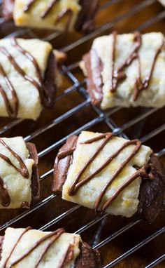 chocolate covered cookies on a cooling rack with drizzled icing over them