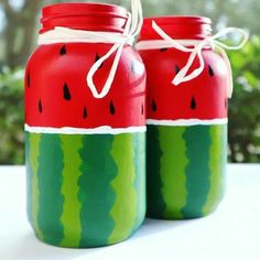 two mason jars with watermelon painted on them