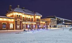 the building is lit up at night in the snow