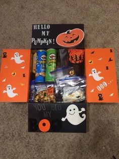 an open halloween gift box with candy and snacks