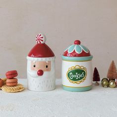 a cookie jar with a santa claus face next to cookies