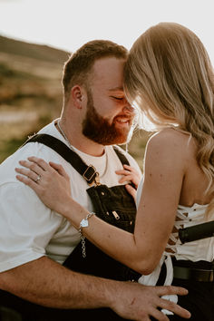 a man and woman are hugging each other