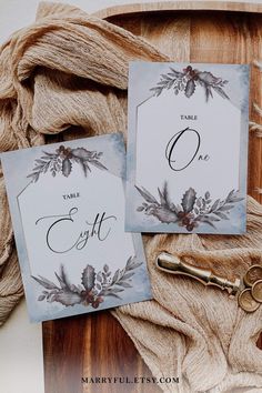 two cards with the letter o on them next to a pair of scissors and yarn