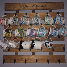 there are many coffee cups hanging on the wall