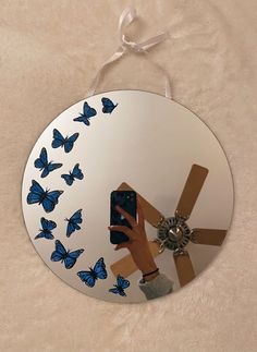 a person taking a selfie in front of a mirror with blue butterflies on it