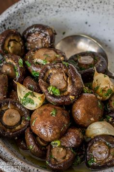 a white bowl filled with mushrooms and onions