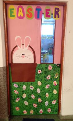 a door decorated with an image of a bunny in a basket and the words easter on it