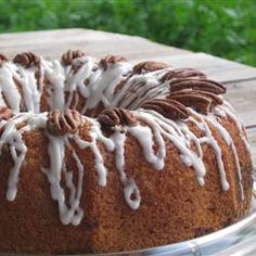 a bundt cake with icing and pecans on top